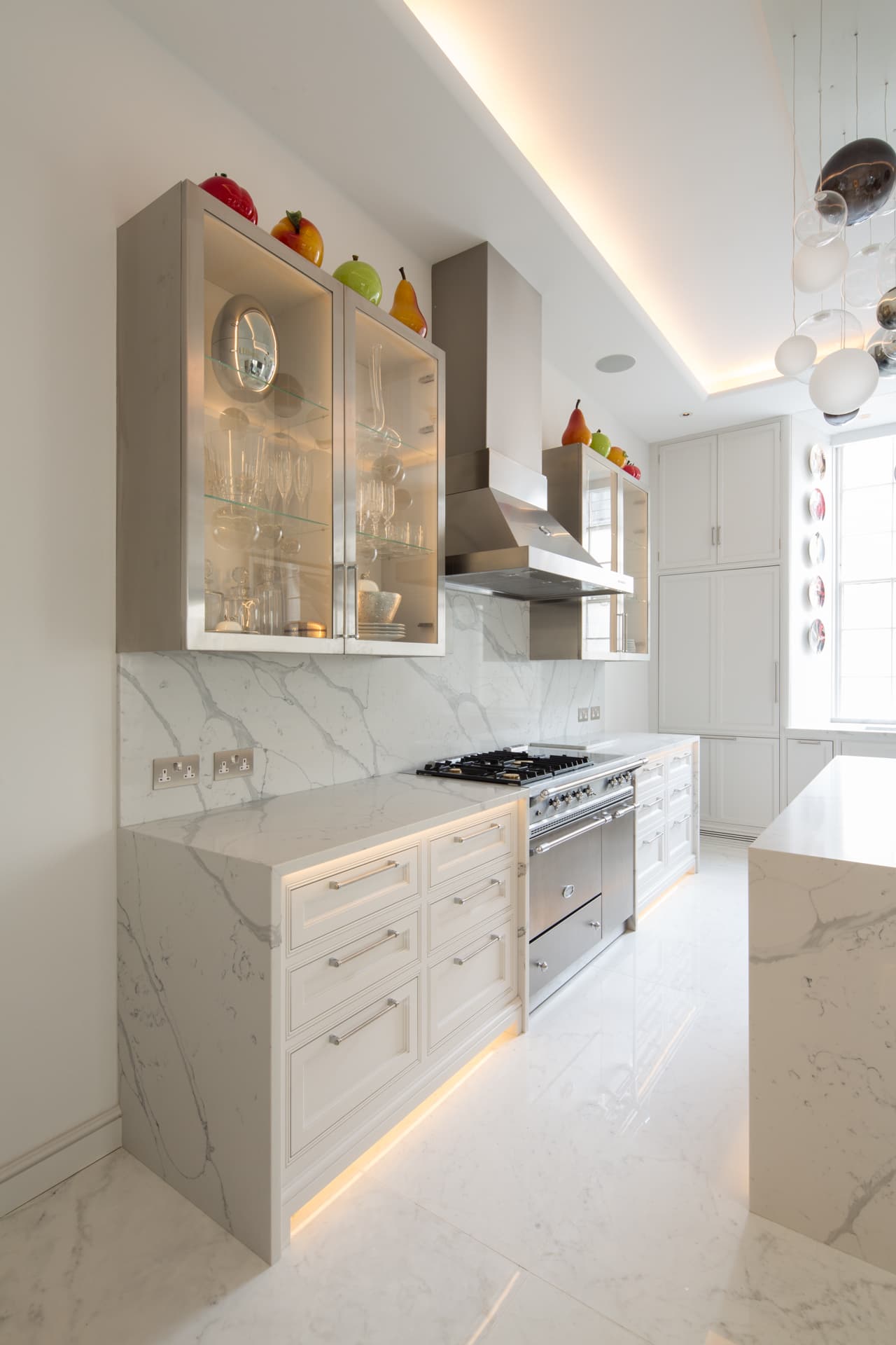Classic white marble kitchen with illuminated glass cabinets