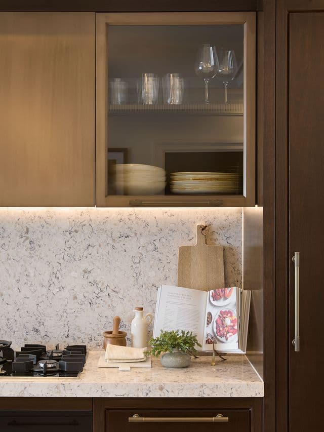 Dark timber glass cabinet with cookbook and glassware