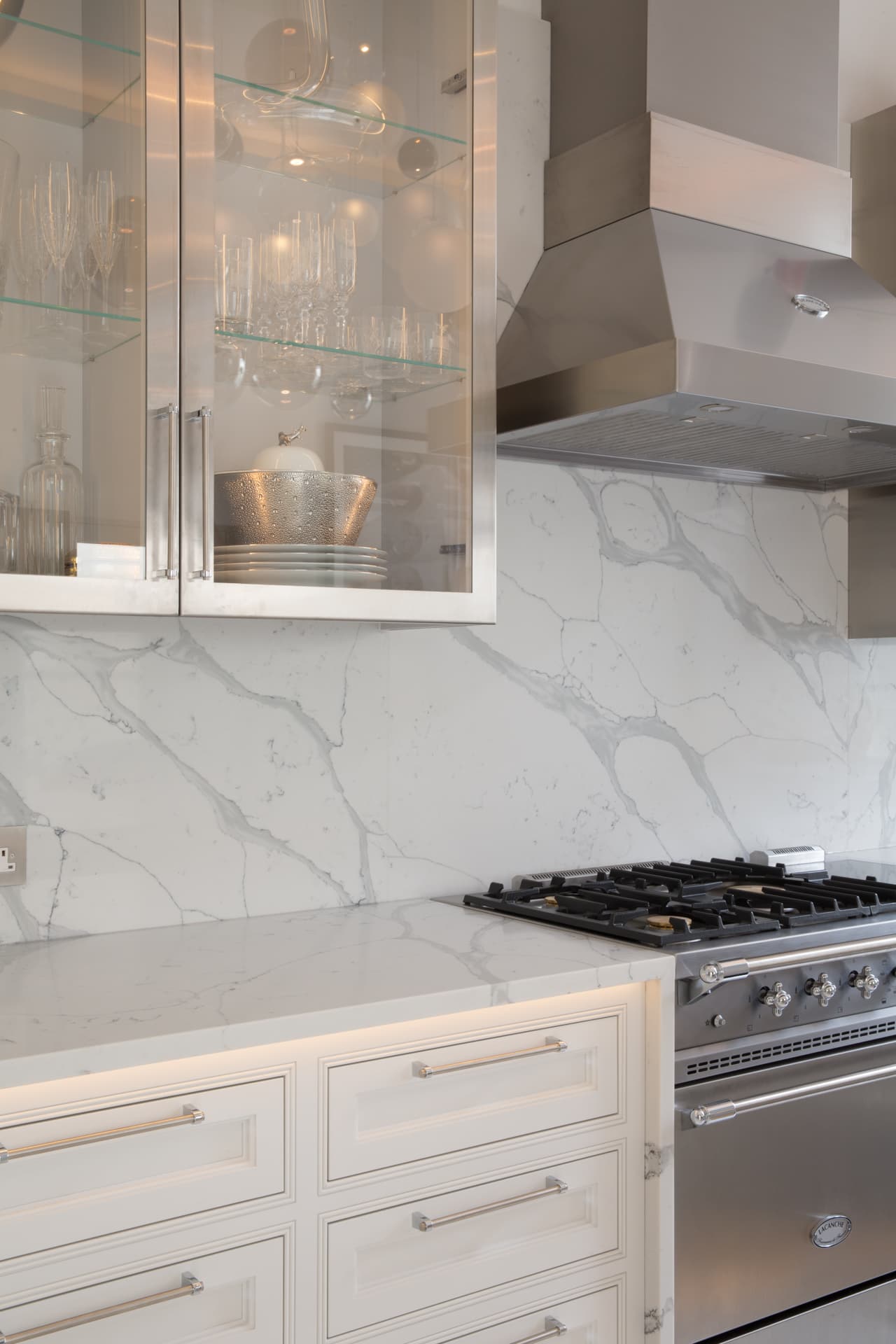 Glass-fronted cabinets flanking professional range cooker