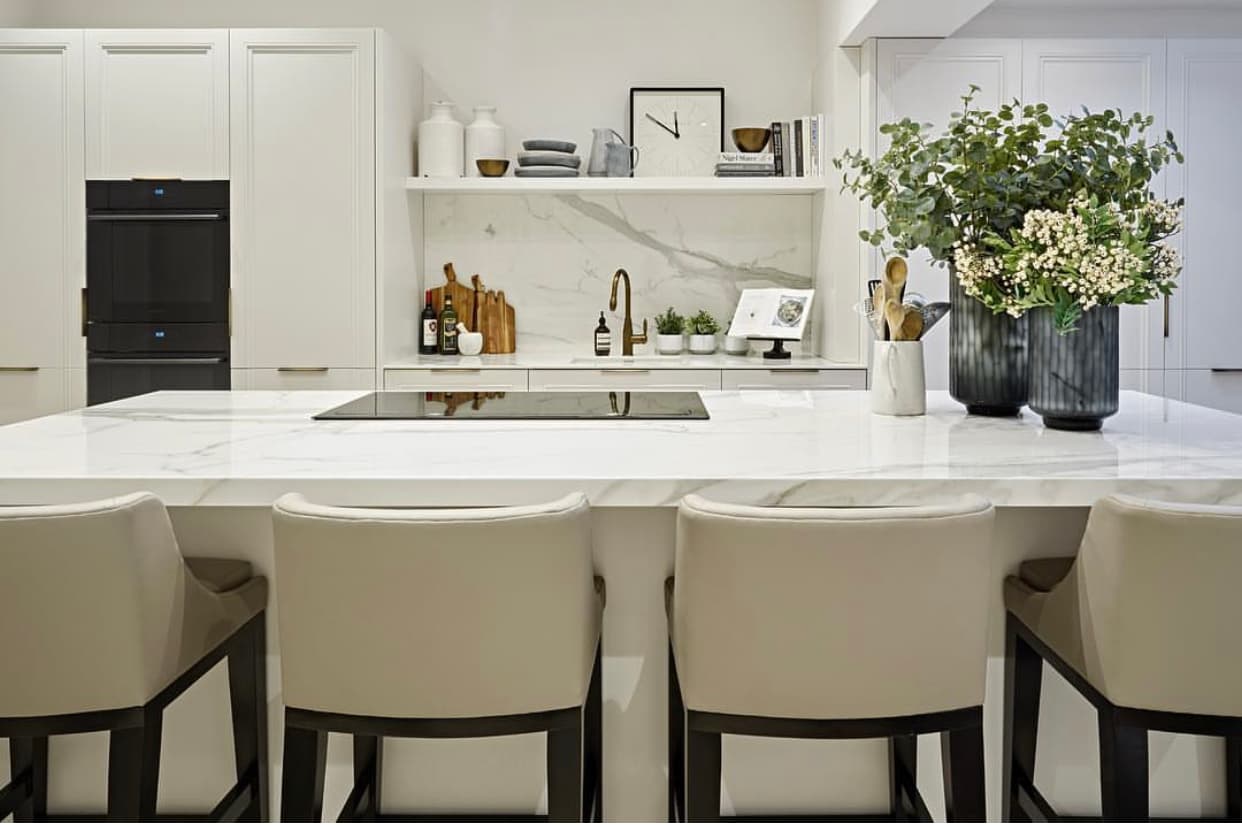 Marble island with styled accessories and integrated hob