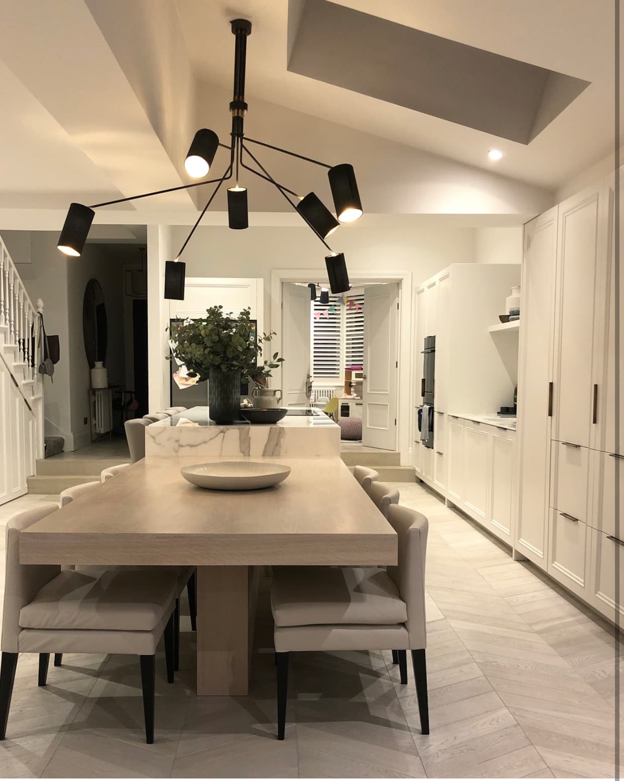 Modern kitchen-diner with herringbone floor and black pendants