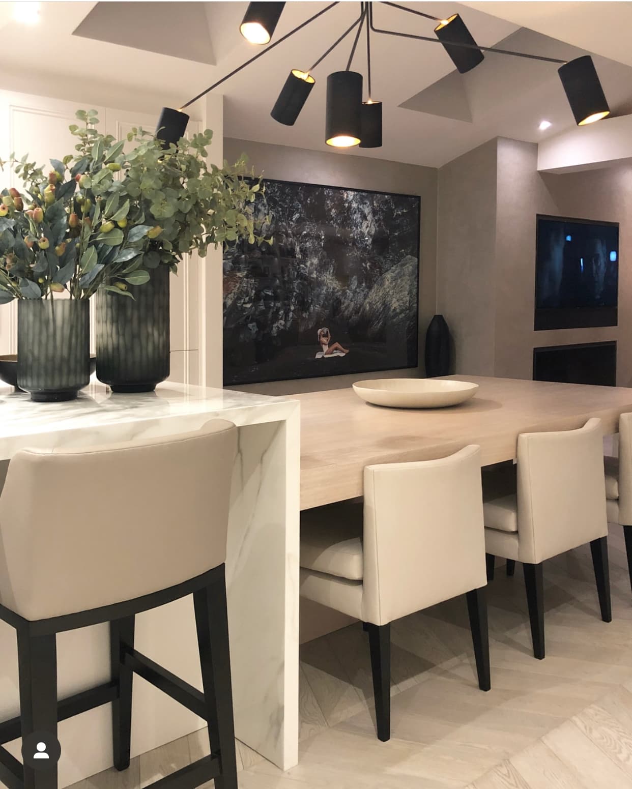 Modern kitchen with waterfall marble island and statement lighting