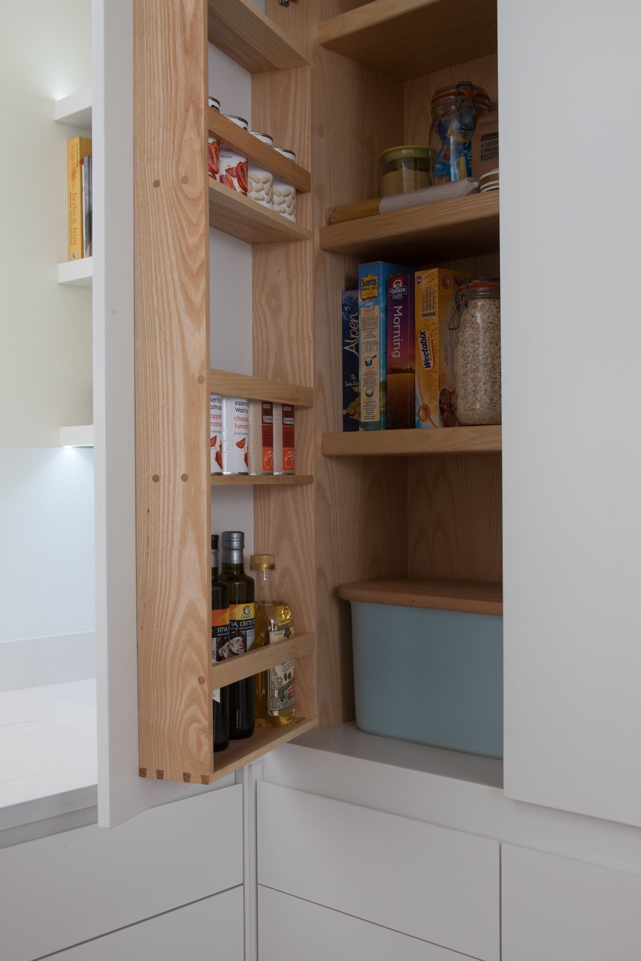 Walk-in pantry with natural timber shelves and dovetail joinery