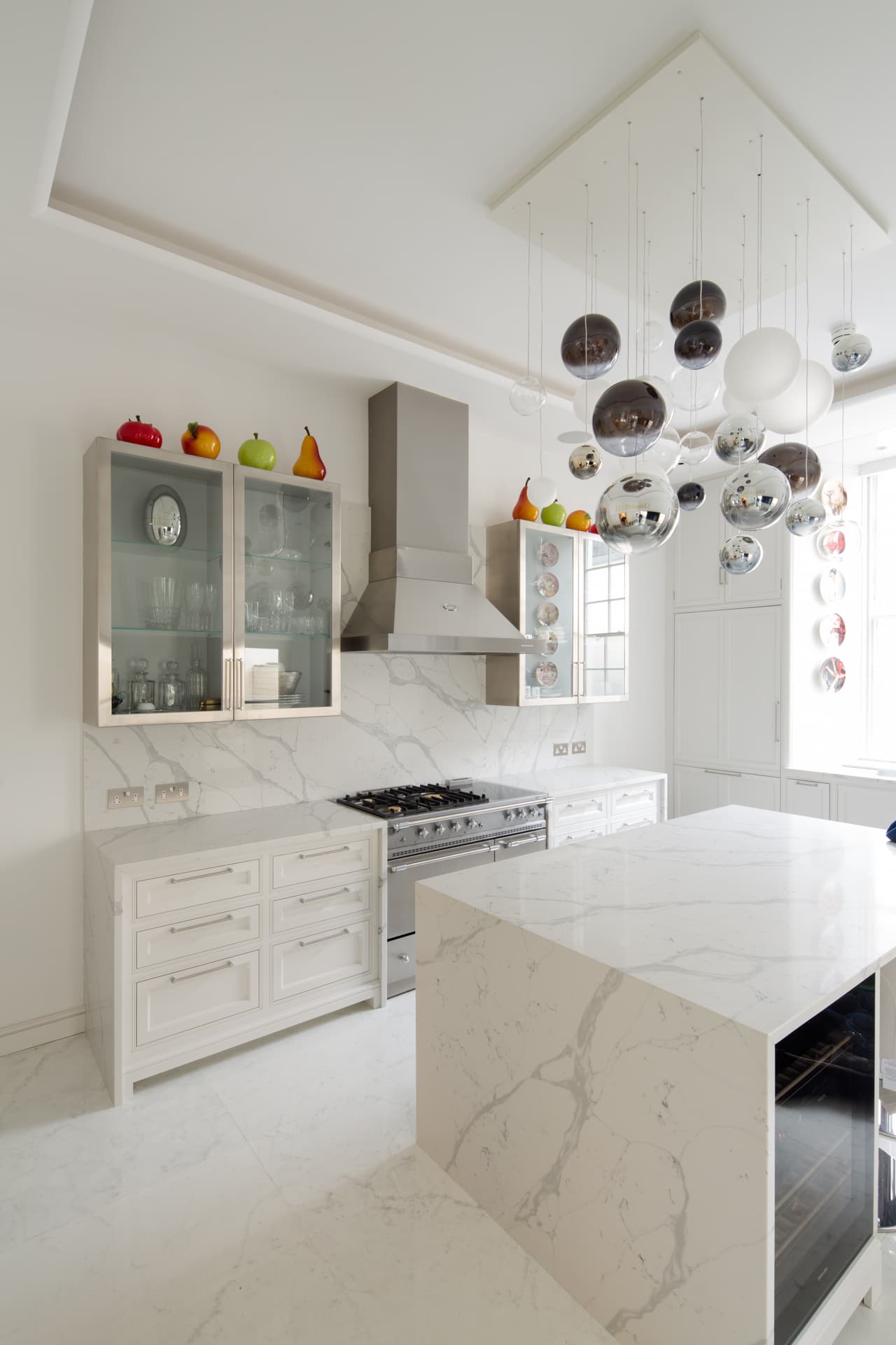 Period white kitchen with marble surfaces and coloured glass