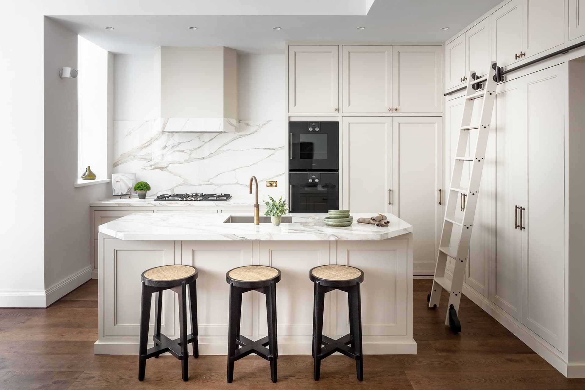 Bespoke kitchen by Albury House Kitchens — marble island with brass tap and handcrafted cabinetry